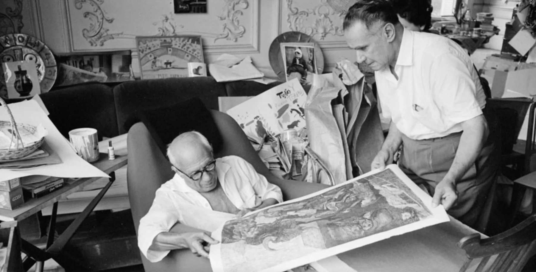 Picasso inspecting an impression of La Minotauromachie with the art dealer and publisher Henri Matarasso, La Californie, Cannes, 1961. Photo: Edward Quinn. © edwardquinn.com . Picasso’s works & likeness © Succession Picasso / DACS, London 2023